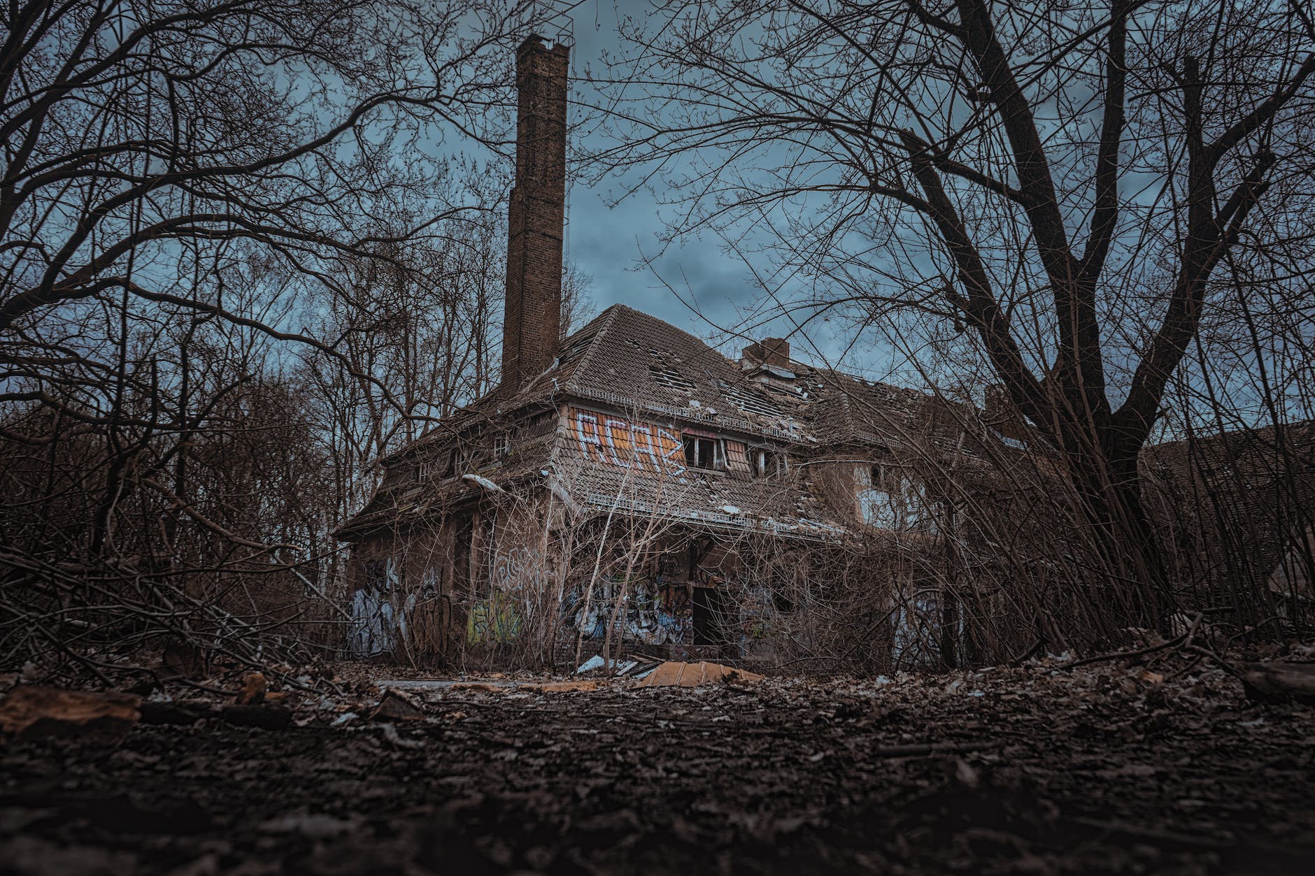 brick house in the middle of the woods under cloudy day sky | The Writer