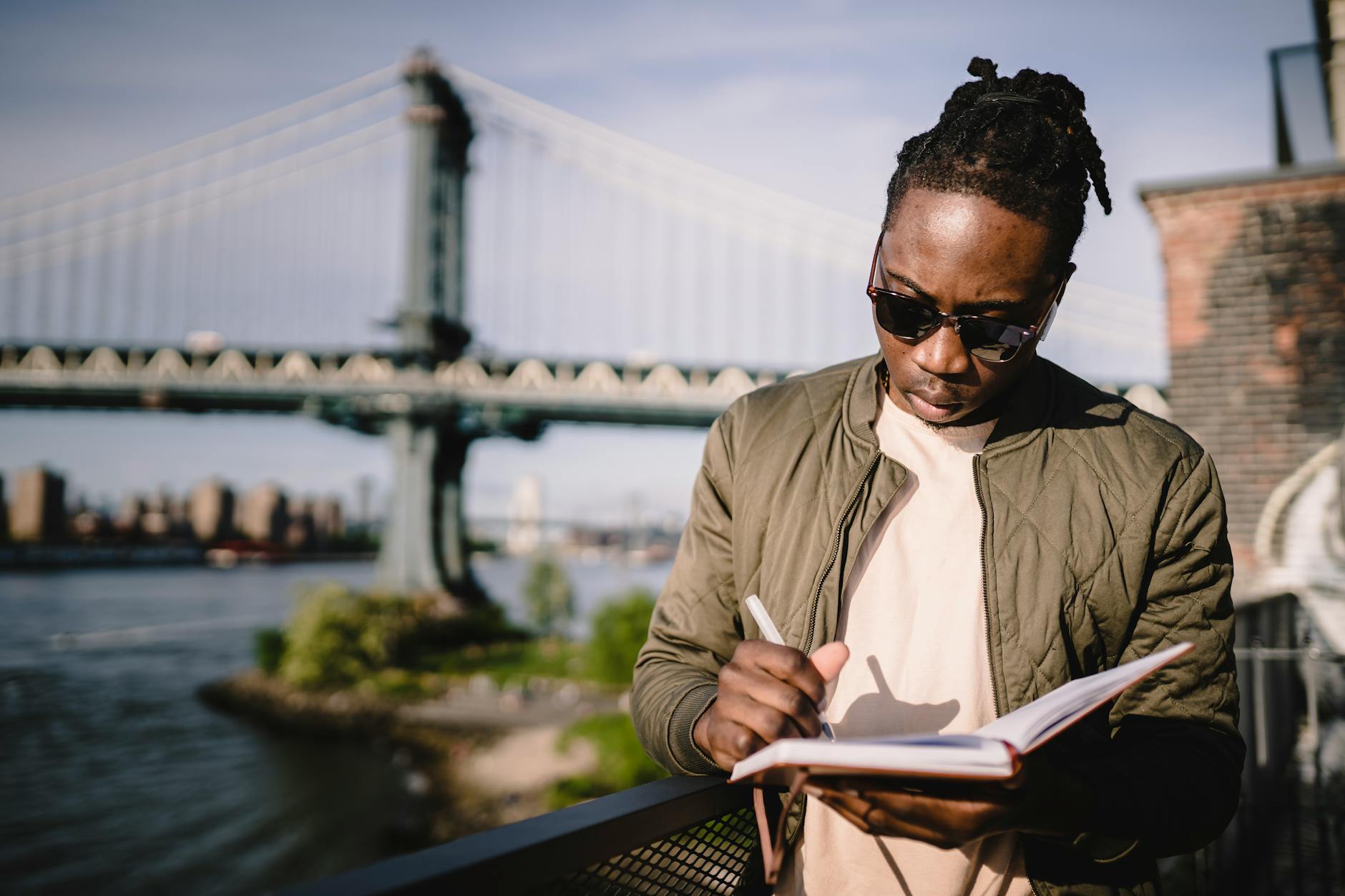 serious african american male with planner on city riverbank | Fitting Necessary Appointments Into Your Schedule