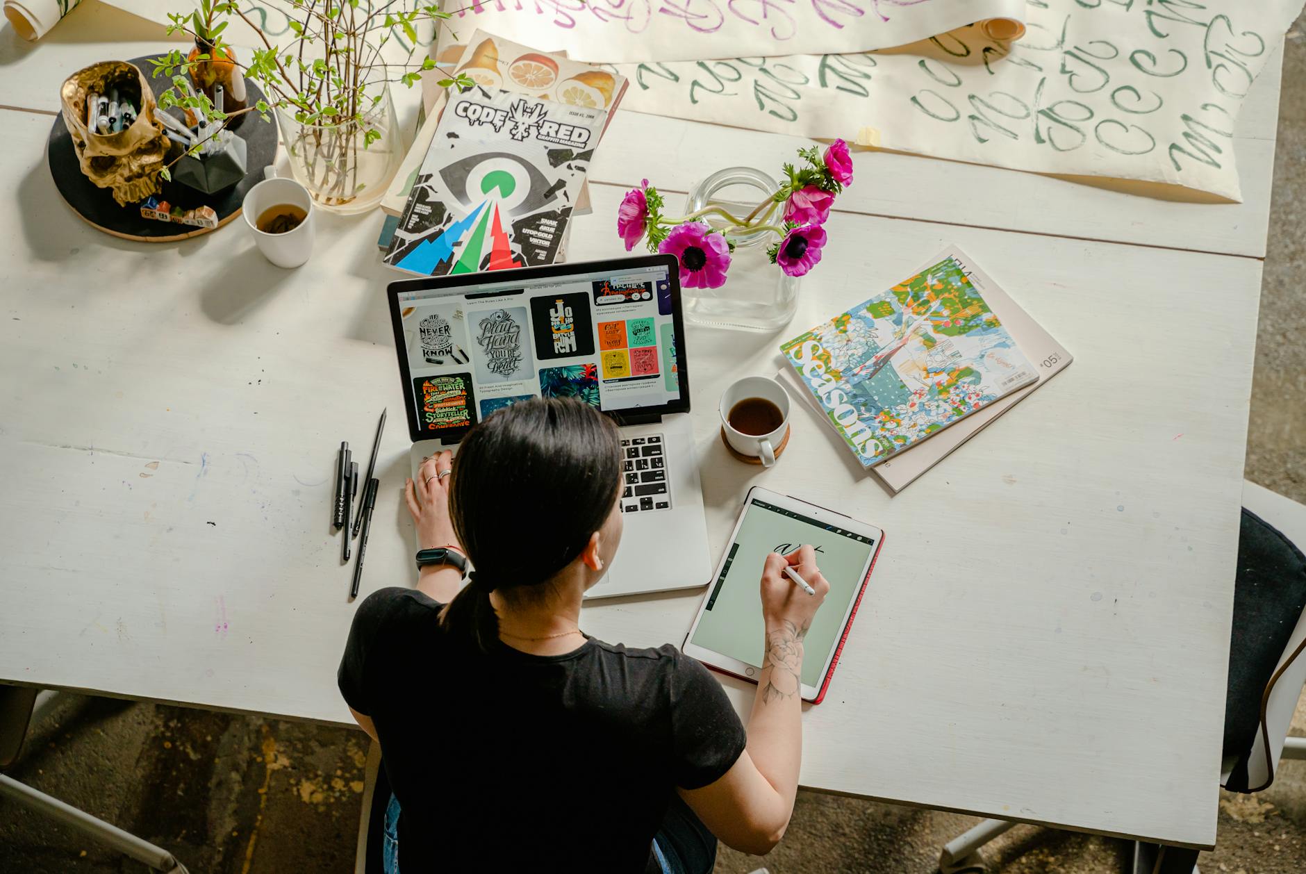 photo of woman writing on tablet computer while using laptop | I'm Just A Busy Bee