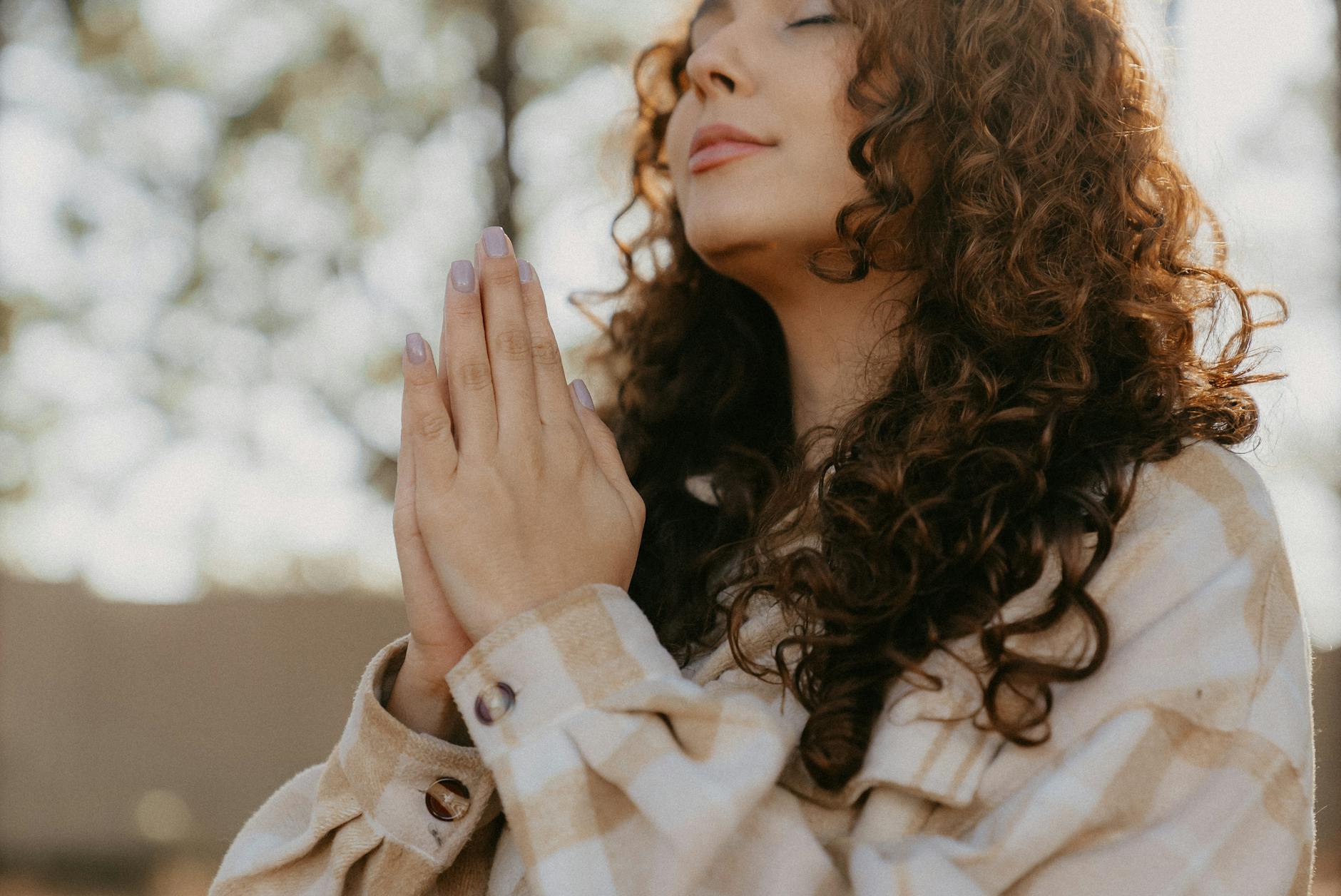 woman praying with hands clasped | Things I Am Grateful For