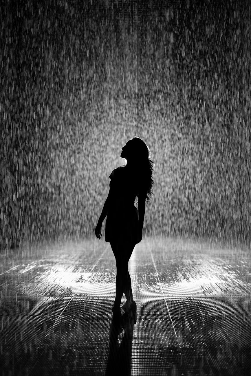 silhouette of woman under rain | Another Rainy Day