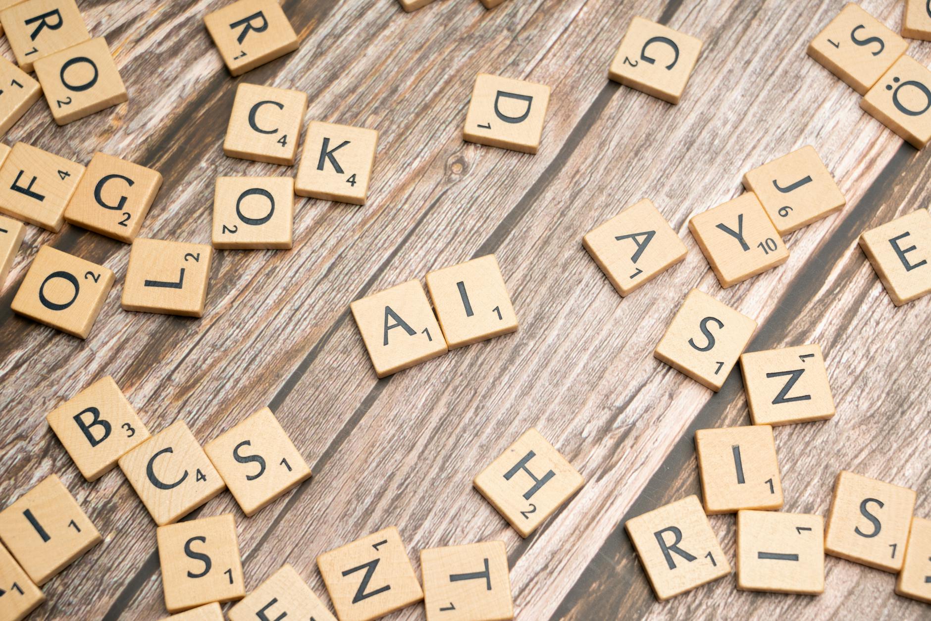 scrabble tiles on a wooden table with the word rock | Creating in the Age of AI