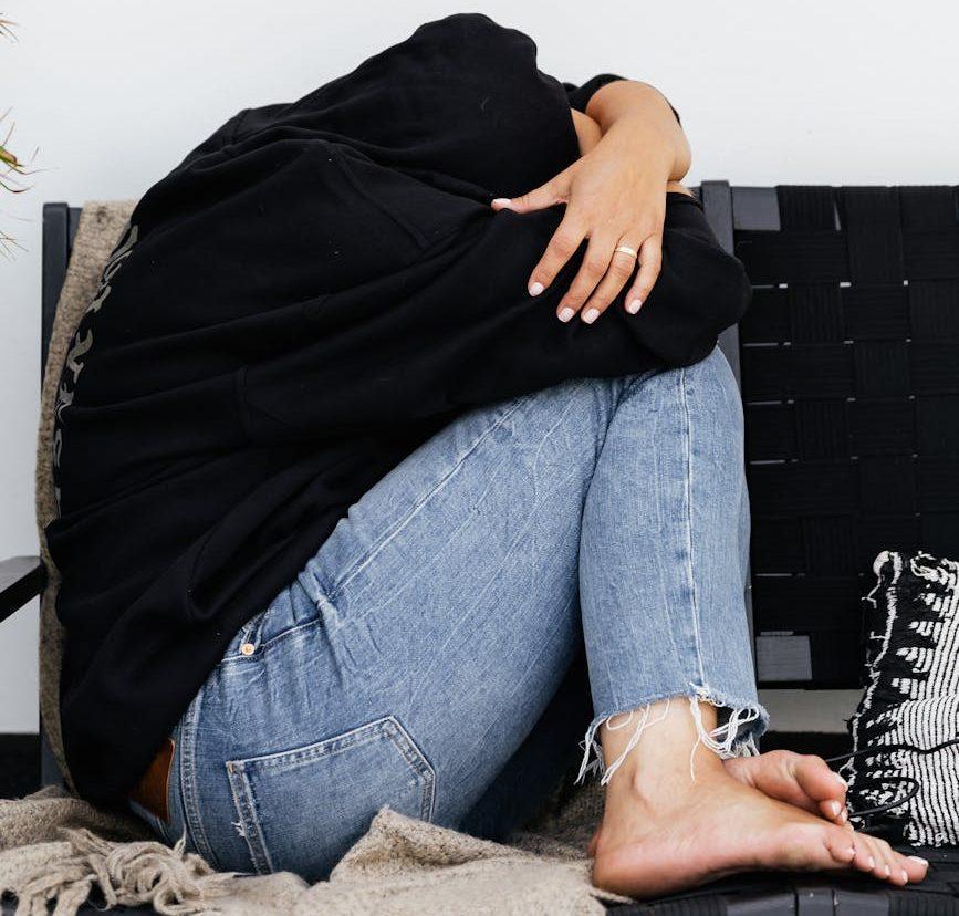 person curled up on sofa | Social Anxiety And Writing